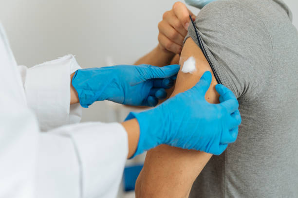istock Nurse sticking cotton plaster on arm after vaccination 1343312575