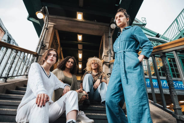 four young woman in berlin on stairs of subway station in berlin - street style imagens e fotografias de stock