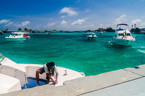 Hulhule island, Maldives - July 11, 2016: Boats at the harbor next to Ibrahim Nasir International Airport in Male, Maldives.
