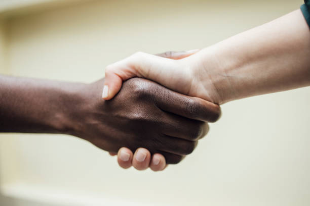 Handshake of a black and a white hand