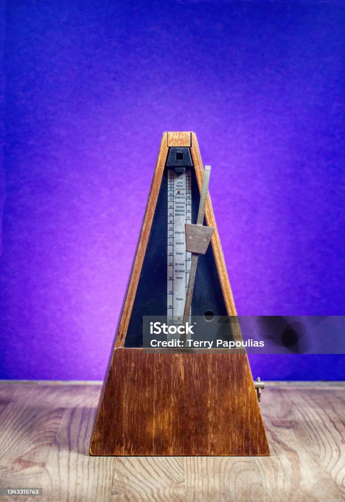 Classic wooden metronome A device used to keep tempo in music. Full, front view photo Intermission Stock Photo