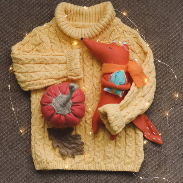 cozy autumn composition with a funny handmade toy fox, fall home decoration