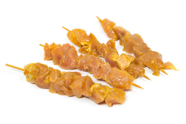 istock Four raw pork skewers on a white background 1343334809