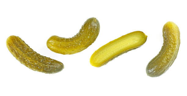 istock Delicious marinated pickled cucumbers isolated on a white background, top view. Canned cucumbers and slices. Gherkins. 1343339558