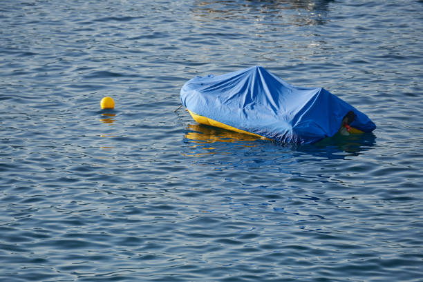 istock Rubber boat covered with a cover in sea water 1343340084