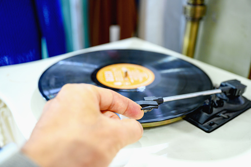 Personal perspective of unrecognizable man playing a turntable, Nikon Z7