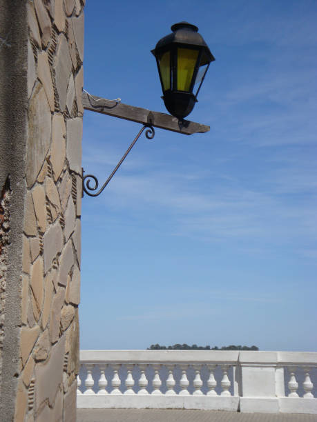 Narrow street, stone houses in a row. Multi colored street light. Old town Pals, Girona province, Catalonia, Spain.