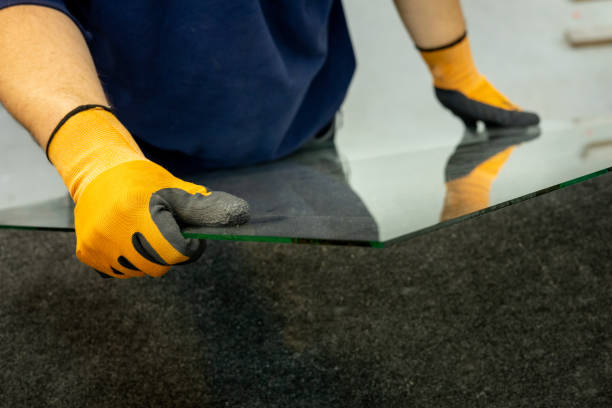 istock glazier holding the glass in his hand 1343342079