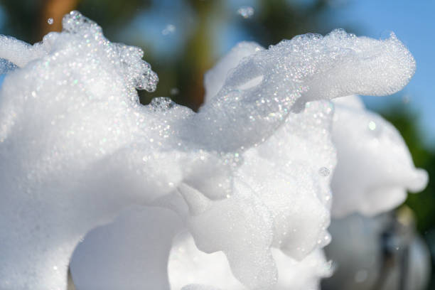 Fun foam party on the beach. Close foam on a blue sky background with palm