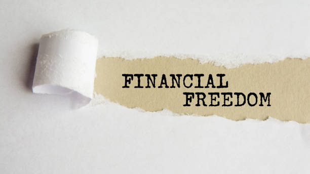 istock financial freedom. words. text on gray paper on torn paper background 1343355710