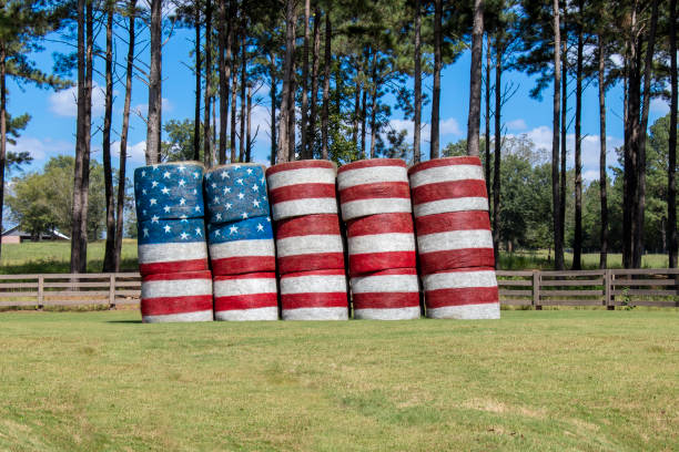 An American flag painted on stacked hay bales. stock photo