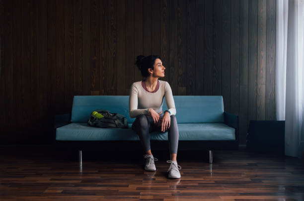 istock Young Woman Sitting on Blue Couch 1343361673