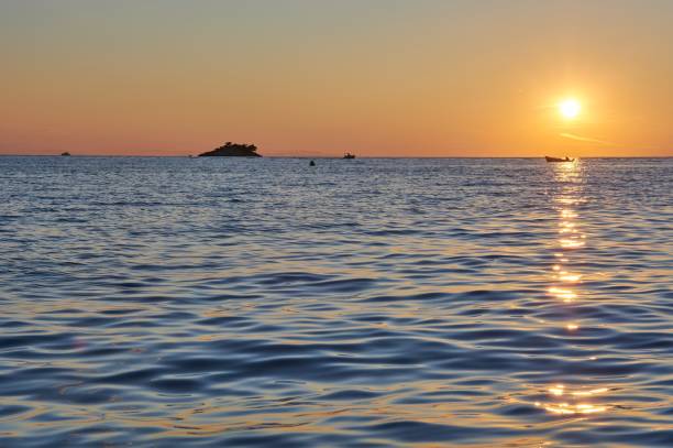 istock Small boat driving in the sunset. 1343364008