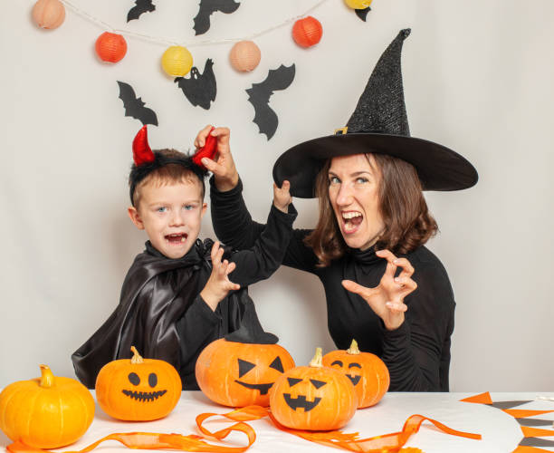 istock Mother and son have fun playing and celebrating Halloween in a witch and devil costume 1343368453