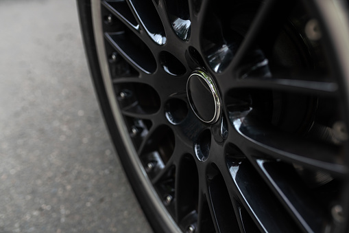 Close-up of a black glossy car rim