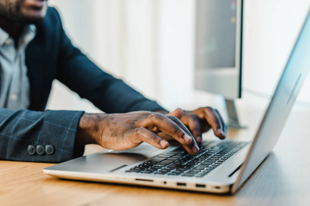 istock Crop black businessman typing on laptop 1343372839