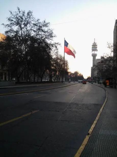 streetview of Santiago, Chile, flag and cityscape.