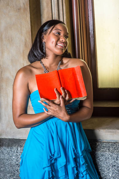 istock Young black girl reading red book, smiling 1343378118