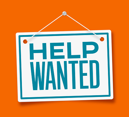 Help wanted hiring recruitment hanging sign on an orange background.