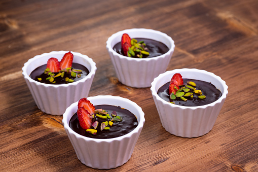 Chocolate and fruit puddings on wooden table