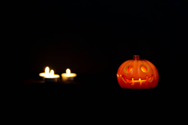 istock Halloween pumpkin with candles on the dark background 1343401554