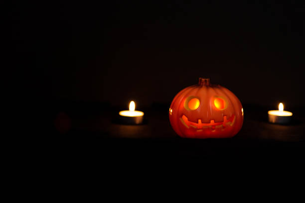 Halloween pumpkin with candles on the dark background