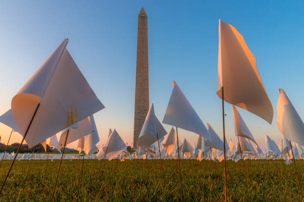Sepia Close Up of Washington Monument with color US Flags.