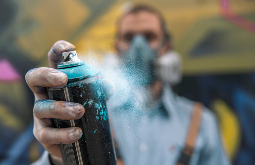 Graffiti Artist Holding Spray Paint Bottle