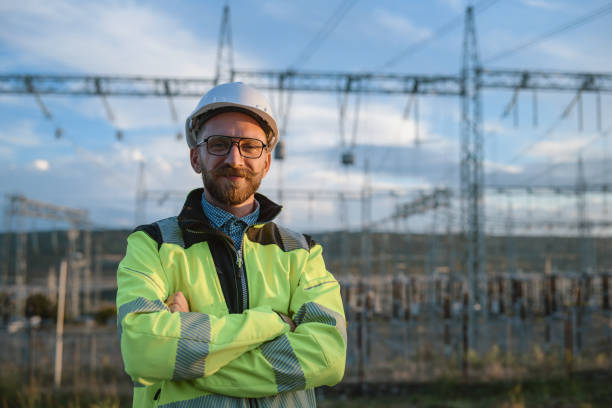 Portrait Of Successful Electrical Engineer In Power Plant Portrait Of Smiling Engineer Looking At The Camera electrician smiling stock pictures, royalty-free photos & images