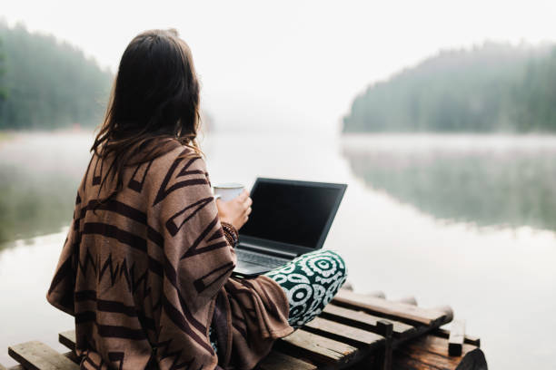 istock Woman Relaxing In Nature And Using Technology 1343404052