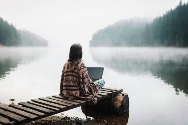 istock Woman Relaxing In Nature And Using Technology 1343404054