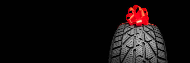 istock black isolation rubber tire, on the grey backgrounds in a bow for christmas 1343404062