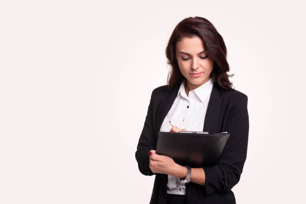 istock Mature female lawyer making notes on clipboard 1343404075