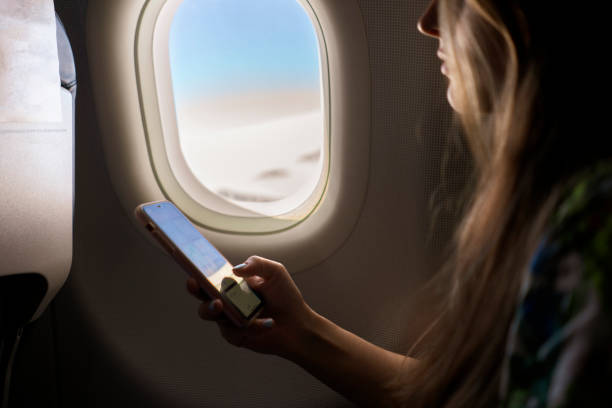 istock young woman using the phone during the flight in the plane 1343405312