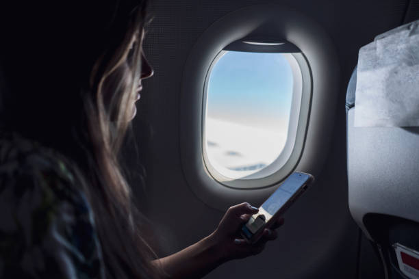 istock young woman using the phone during the flight in the plane 1343405324