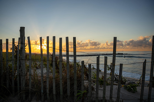 Fence on Sand Dunes at The Beach at Sunset