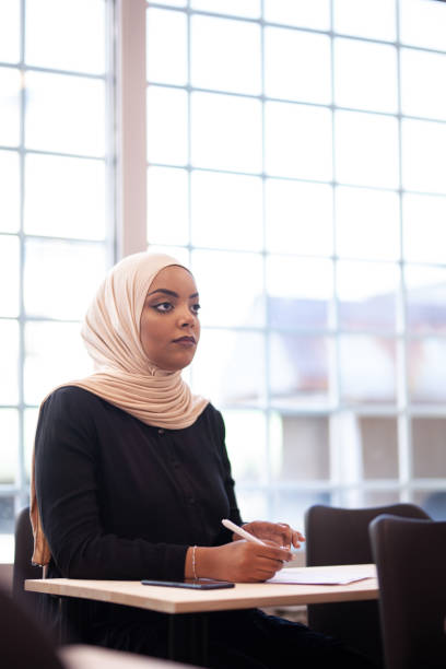istock Multi ethnic students listening to a lecturer in a classroom. Smart young people study at a college. 1343407878