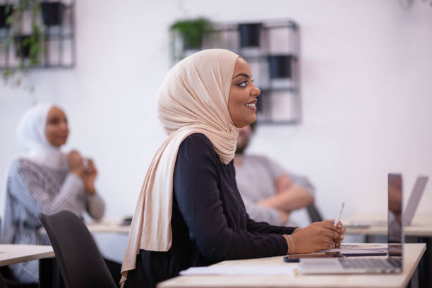 istock Multi ethnic students listening to a lecturer in a classroom. Smart young people study at a college. 1343407883