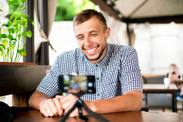 istock young person speaking on camera and doing online seminar, internet course 1343412537