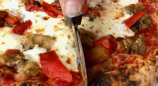 istock Cutting Pizza Close-Up with Pizza Cutter Wheel 1343416229