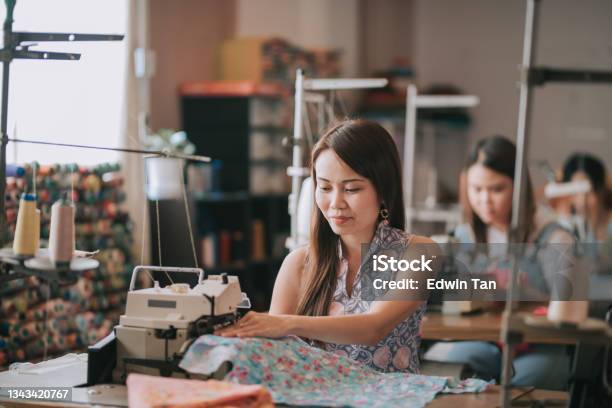 Asian Chinese Female Blue Collar Worker Working In Sewing Studio In A Row Stock Photo - Download Image Now