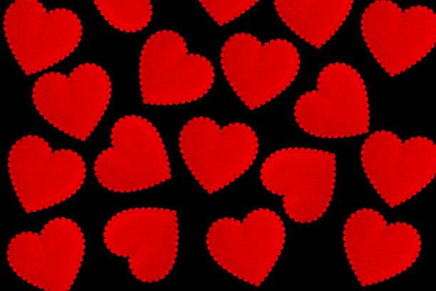 Red hearts on black background. hearts texture. hearts background