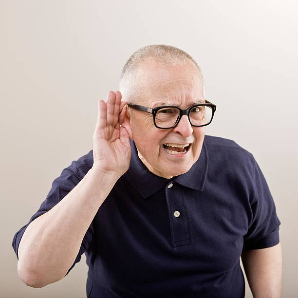 And older man cupping his ear to hear Older man cupping his ear having difficulty hearing old man cupping his ear to hear something stock pictures, royalty-free photos & images