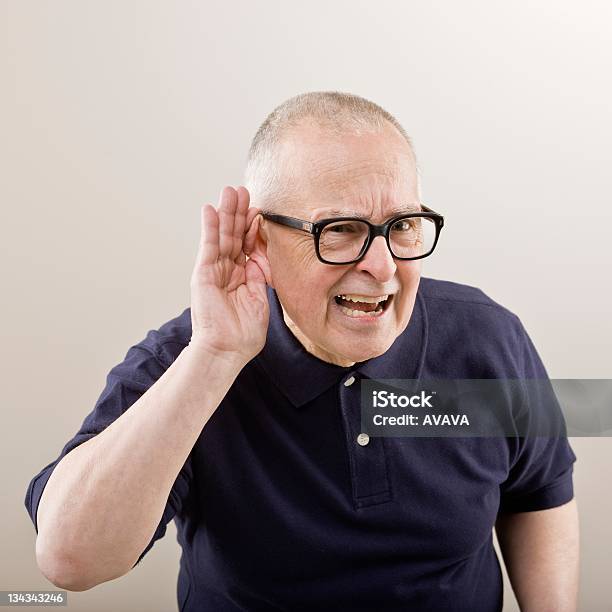 And Older Man Cupping His Ear To Hear Stock Photo - Download Image Now - 70-79 Years, Adult, Adults Only