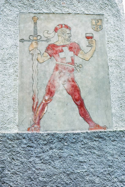 1980s Street View, Painting on the side of a building, Zuoz, Switzerland Old Retro Vintage Style photo Swiss man with sword and a glass of wine, painted on the side of a building, 1980s Street View, Zuoz, Switzerland. 1980 1989 photos stock pictures, royalty-free photos & images