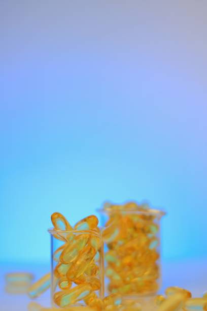 istock Fish oil capsules in laboratory flasks on a light blue background.Omega 3 capsules. Natural supplements and vitamins.omega fatty acids. Healthy eating and food supplements 1343445940