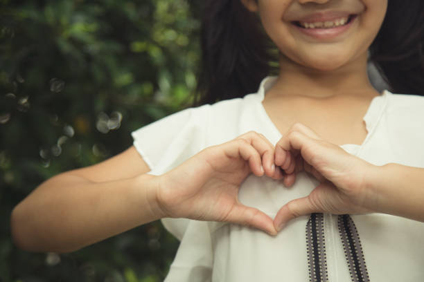 istock Little girl hands making a heart shape on white background 1343446025