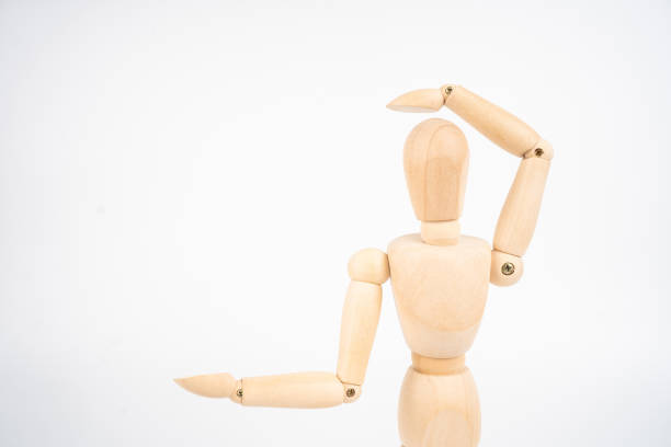 istock Wooden artist's dummy, confused by new idea (isolated on white background, copy space for your object or text) 1343447119