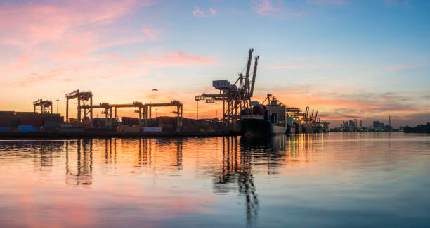 istock Panorama of Container Cargo freight ship in shipyard with sunrise 1343448069