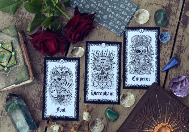 istock Fortune telling ritual with tarot cards, roses and crystals on witch table. 1343448320